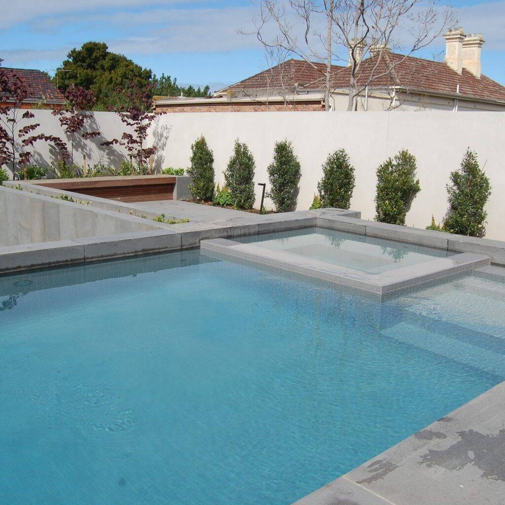 Luxury swimming pool finished with 48mm Grigio Light Grey Porcelain Pool Tiles.