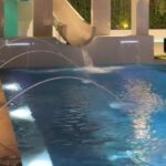 Luxury LED Laminar Water Jets for Swimming Pools Luxury swimming pool with colour-changing LED laminar water jets at night