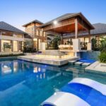 Premium white in-pool loungers on a tanning ledge with glass mosaic pool tiles in Maudsland, Queensland