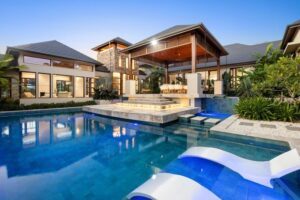 Luxury glass mosaic swimming pool with premium in-pool loungers at a modern home in Maudsland, Queensland